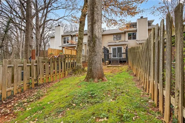a yellow house with trees in front of it