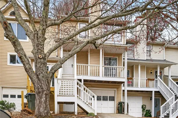 a front view of a building with a tree