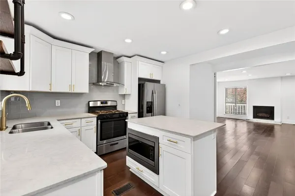 a kitchen with a stove a sink and a refrigerator