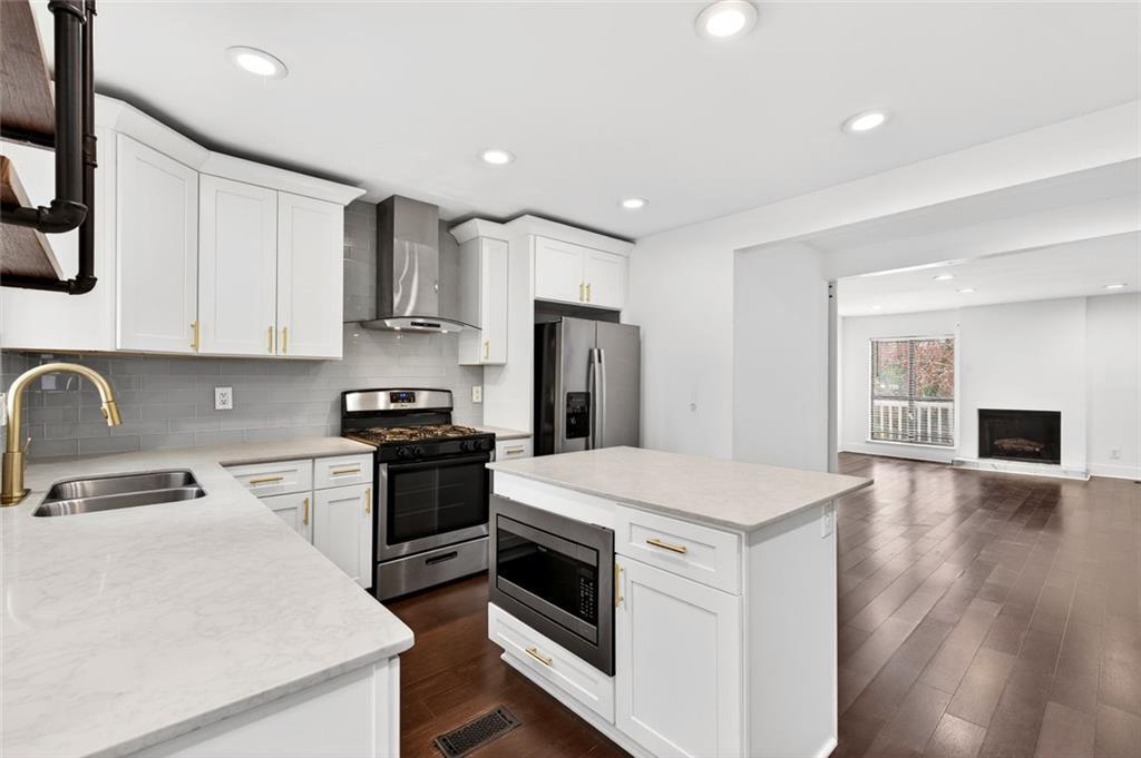 2226 Spring Walk Court Atlanta, GA 30341 - Photo 5 of 28 a kitchen with a stove a sink and a refrigerator