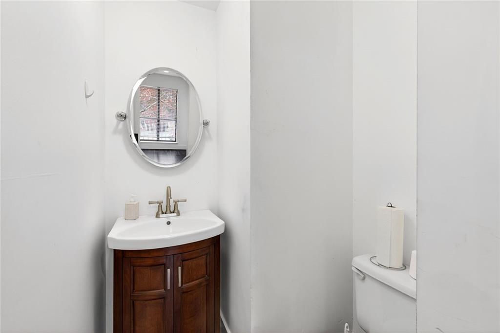 2226 Spring Walk Court Atlanta, GA 30341 - Photo 10 of 28 a bathroom with a toilet a sink and mirror