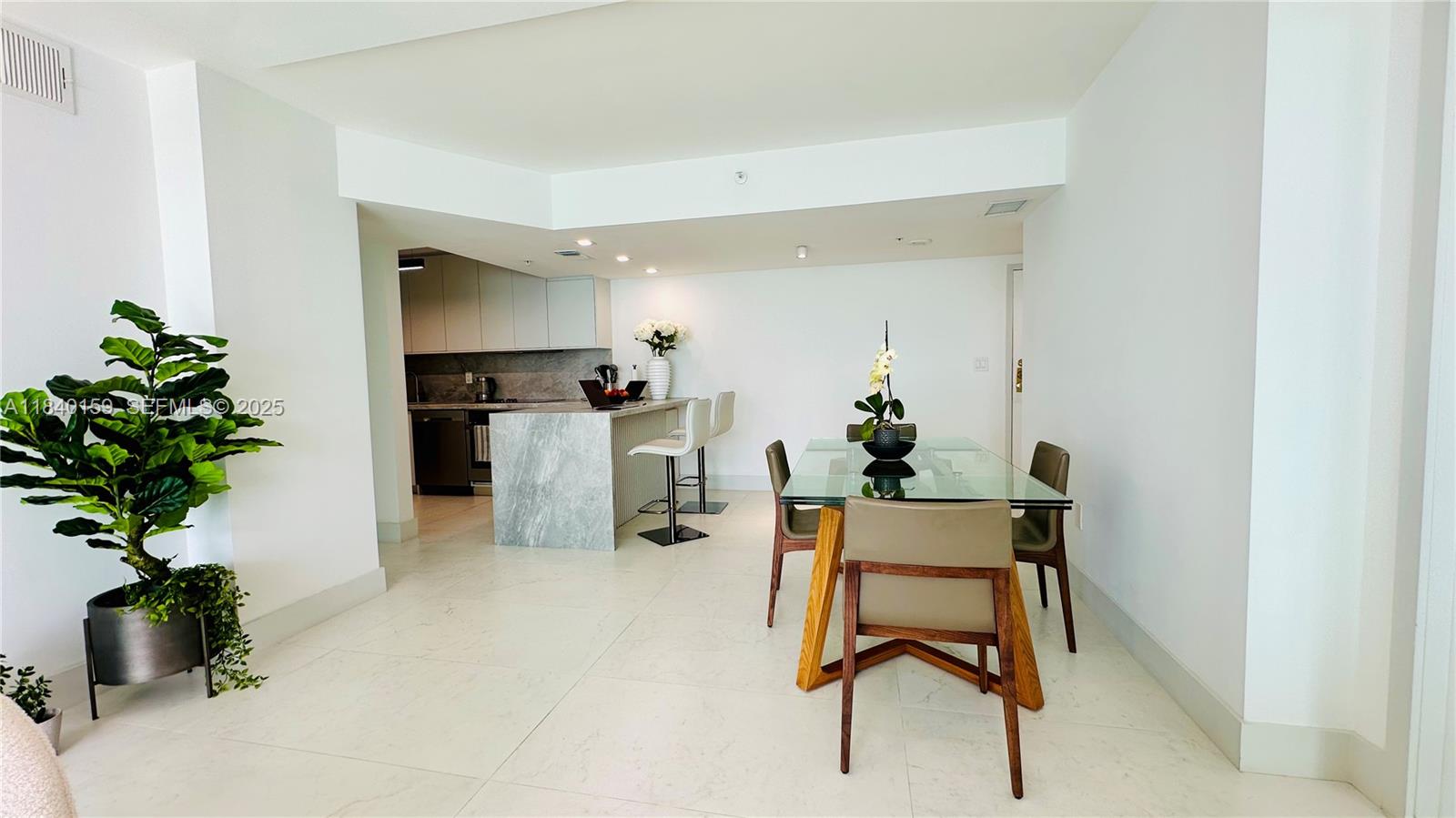 800 Claughton Island Drive, Unit 1903 Miami, FL 33131 - Photo 16 of 34 a room with furniture and a potted plant