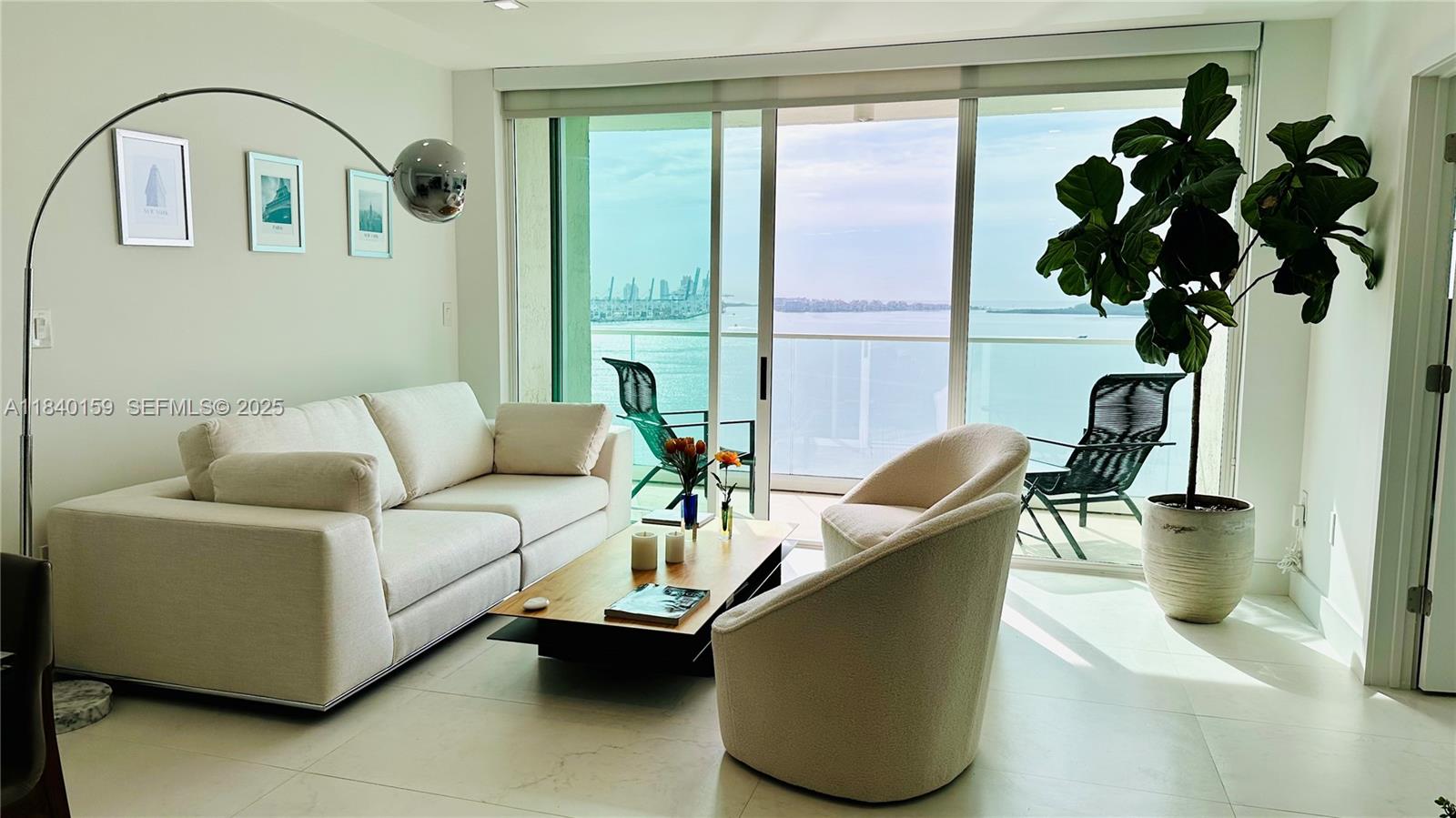 800 Claughton Island Drive, Unit 1903 Miami, FL 33131 - Photo 24 of 34 a living room with furniture and a potted plant