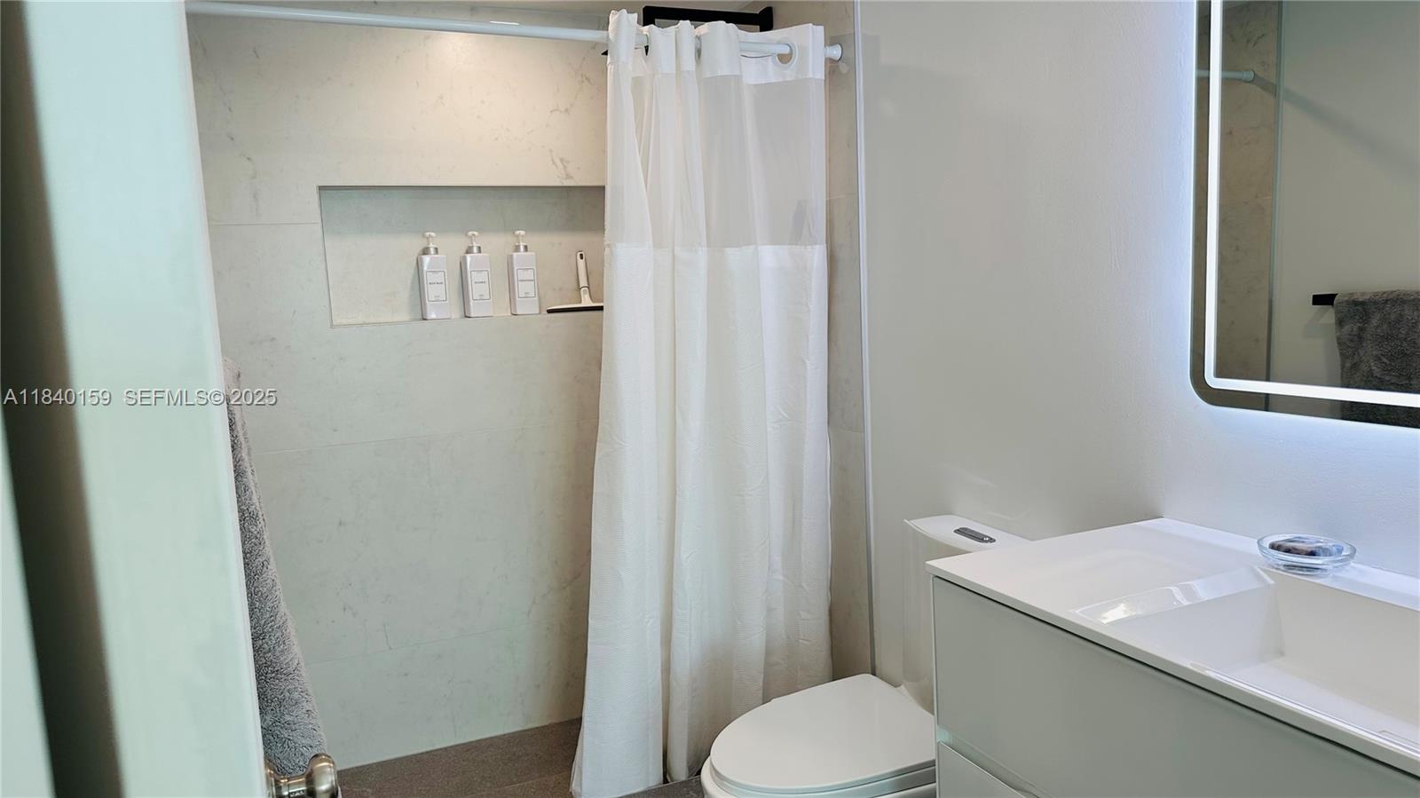 800 Claughton Island Drive, Unit 1903 Miami, FL 33131 - Photo 26 of 34 a bathroom with a sink toilet and shower