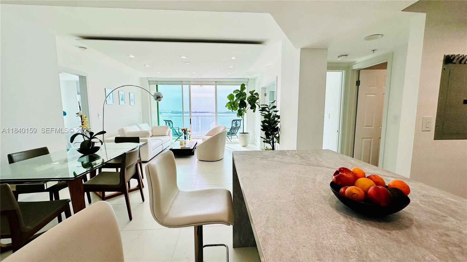 800 Claughton Island Drive, Unit 1903 Miami, FL 33131 - Photo 8 of 34 a view of a dining room with furniture and wooden floor