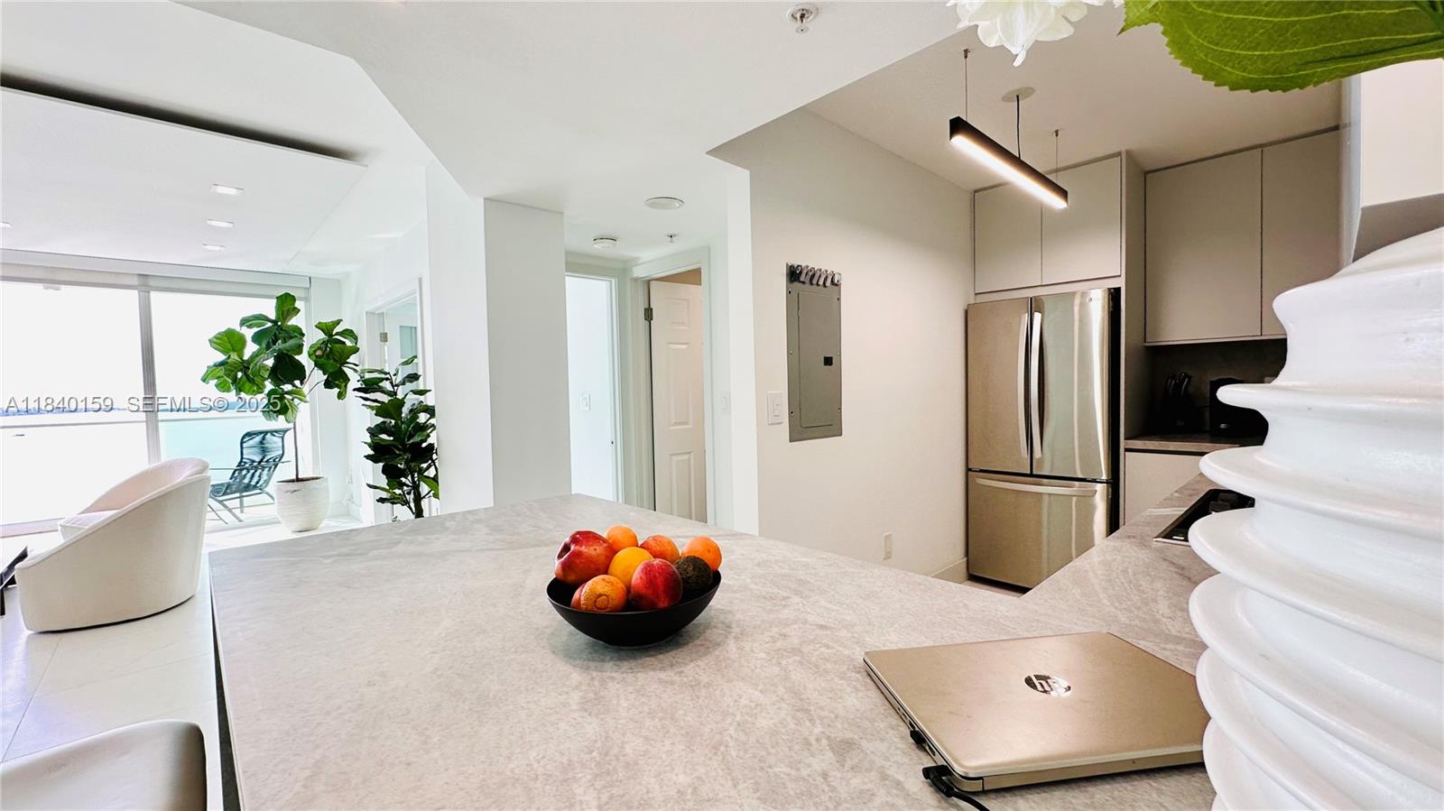 800 Claughton Island Drive, Unit 1903 Miami, FL 33131 - Photo 9 of 34 a view of furniture and potted plant