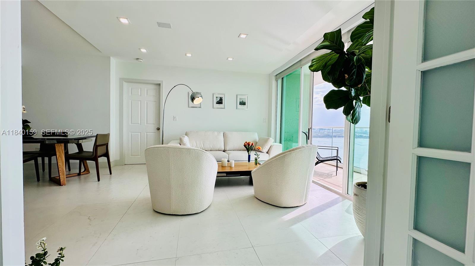 800 Claughton Island Drive, Unit 1903 Miami, FL 33131 - Photo 10 of 34 a living room with furniture and a window