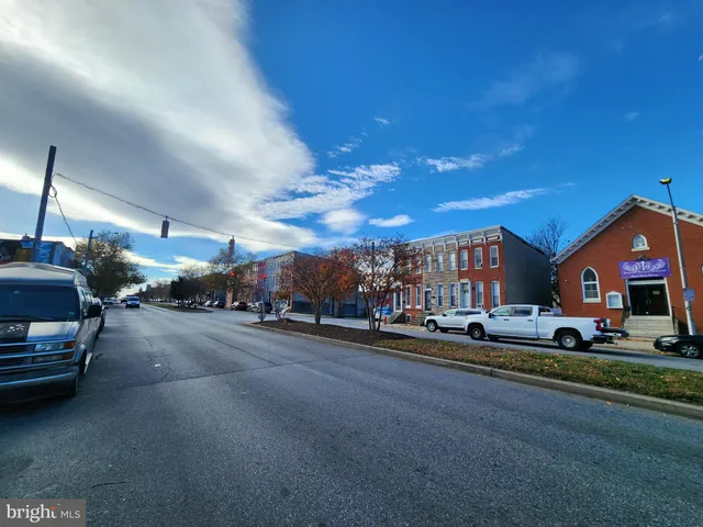 a city street lined with buildings and cars parked in front of it