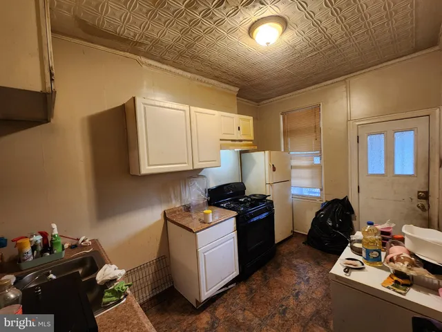 a kitchen with a stove and a refrigerator
