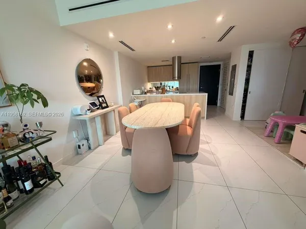 a large kitchen with stainless steel appliances kitchen island granite countertop a sink a stove and a wooden floors
