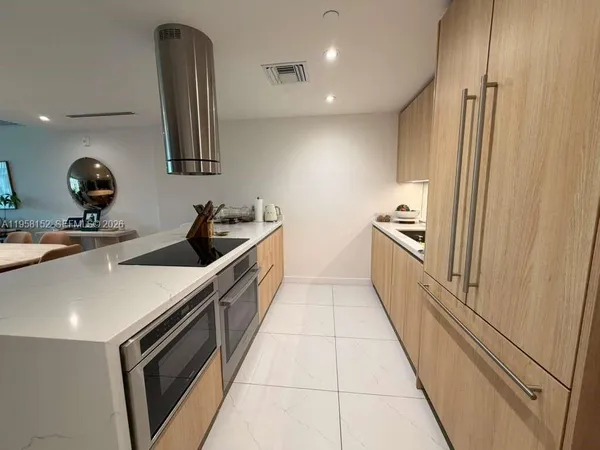 a kitchen with granite countertop a sink and cabinets