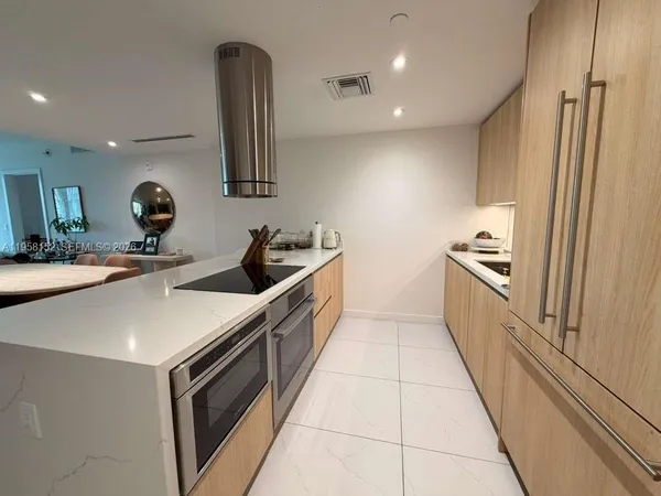 a kitchen with a sink and appliances