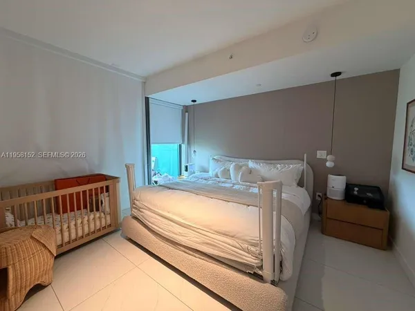 a bedroom with bed and a window