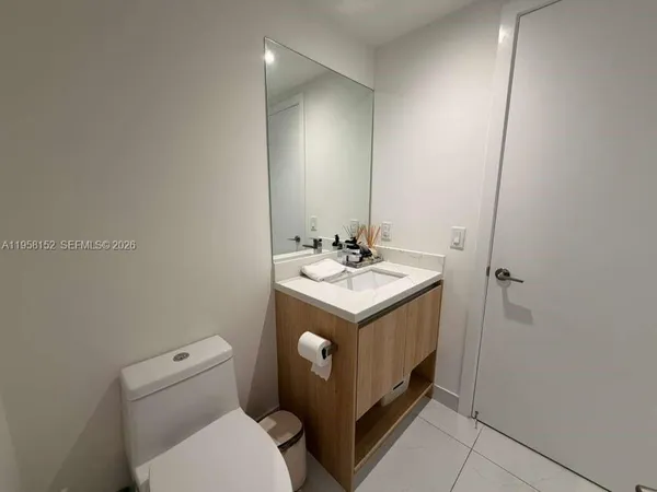a bathroom with a sink toilet and vanity