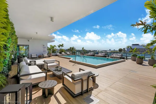a view of a patio with couches and pool