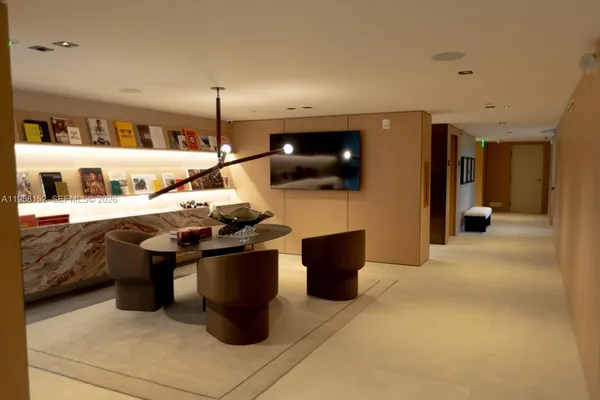 a living room with lots of furniture and clutter