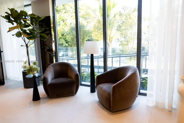 a living room with furniture and a potted plant