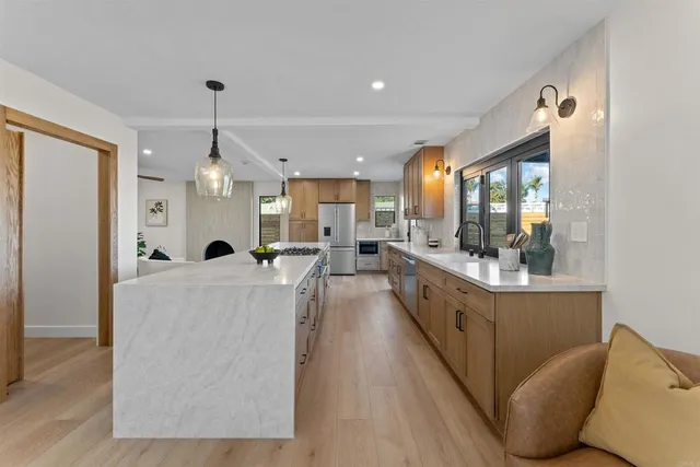 a kitchen with sink and large window