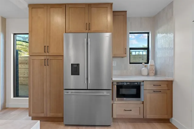 a kitchen with a large window and sink