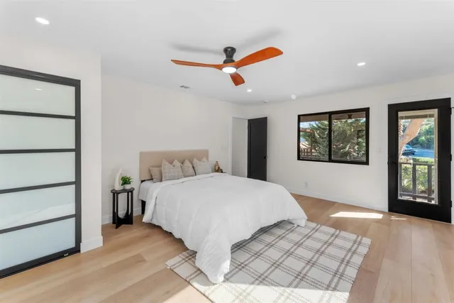 a bedroom with a bed and a painting on the wall