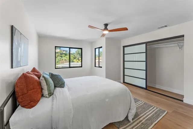 a bedroom with a large bed and a window