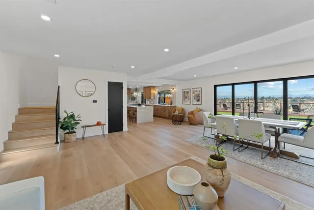 a living room with furniture and floor to ceiling windows