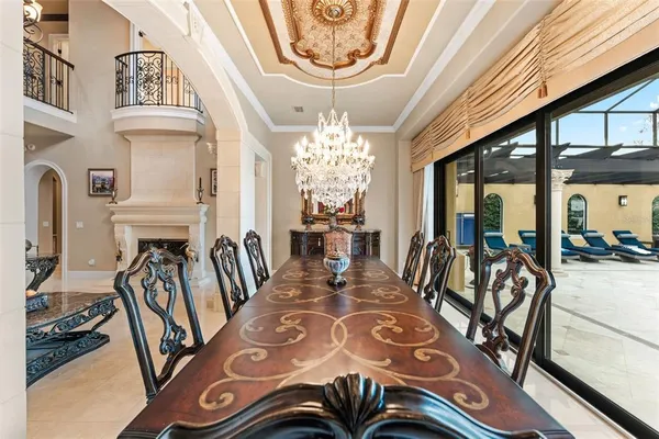 a living room with furniture a fireplace and a chandelier