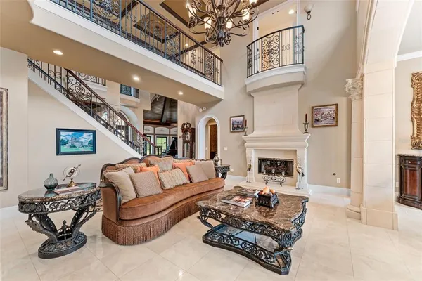 a living room with furniture a chandelier and a fireplace