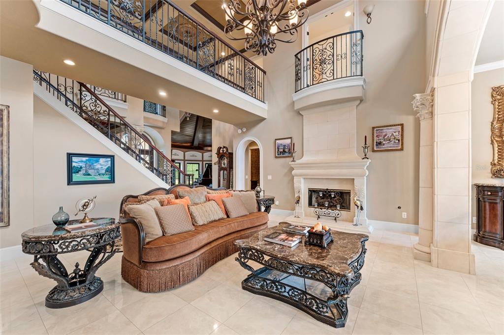 5070 Down Point Lane Windermere, FL 34786 - Photo 14 of 57 a living room with furniture a fireplace and a chandelier