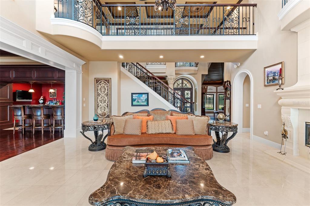 5070 Down Point Lane Windermere, FL 34786 - Photo 15 of 57 a living room with furniture a chandelier and a fireplace