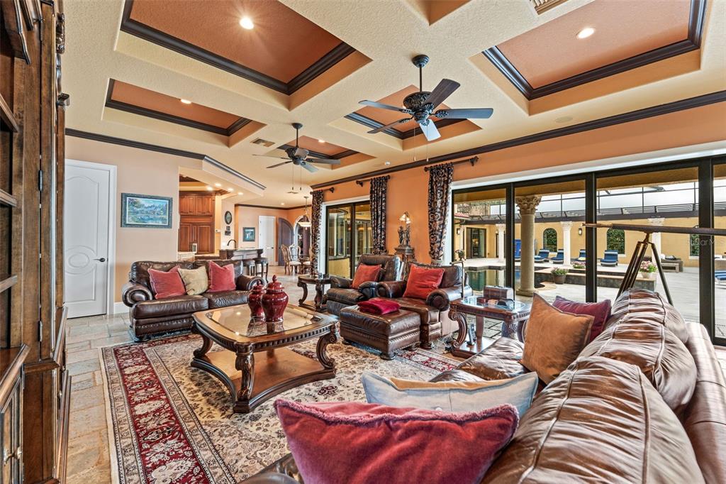 5070 Down Point Lane Windermere, FL 34786 - Photo 21 of 57 a living room with furniture a ceiling fan and a large window