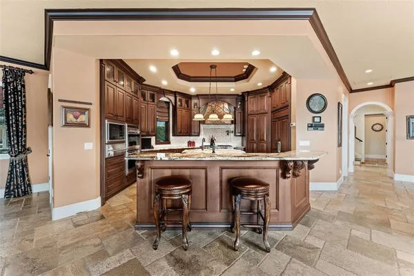 a kitchen with granite countertop a stove and a refrigerator