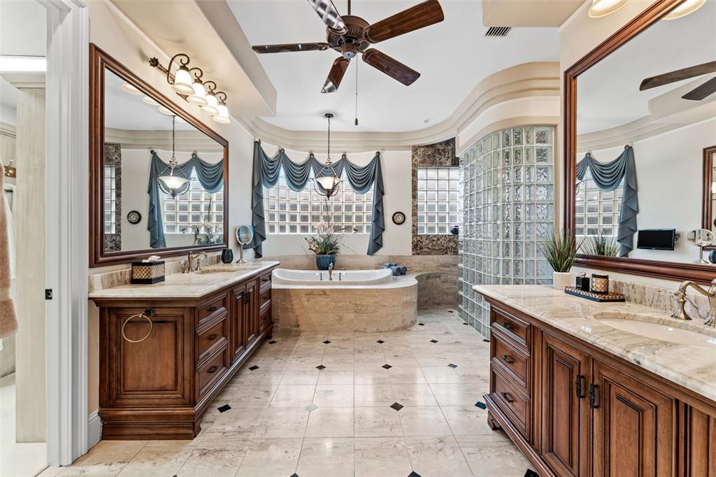 5070 Down Point Lane Windermere, FL 34786 - Photo 31 of 57 a spacious bathroom with a double vanity sink mirror and bathtub