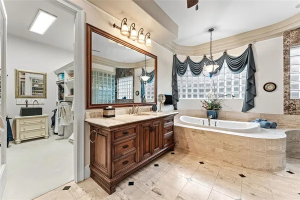 a spacious bedroom with a bed and a chandelier