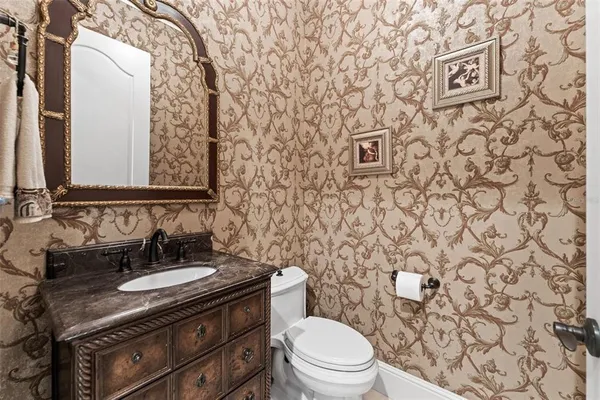 a bathroom with a granite countertop sink a mirror and shower