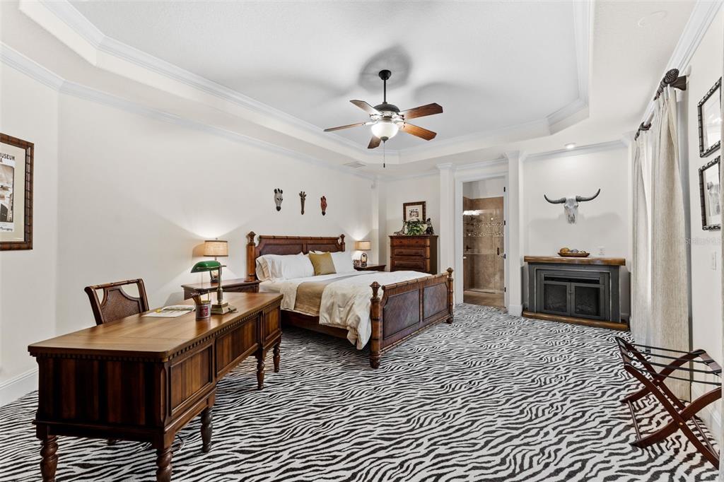 5070 Down Point Lane Windermere, FL 34786 - Photo 37 of 57 a spacious bedroom with a bed and a chandelier