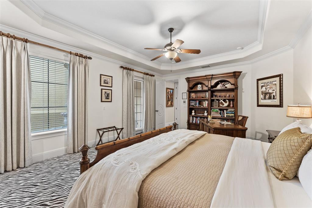 5070 Down Point Lane Windermere, FL 34786 - Photo 38 of 57 a bedroom with a large bed and a chandelier