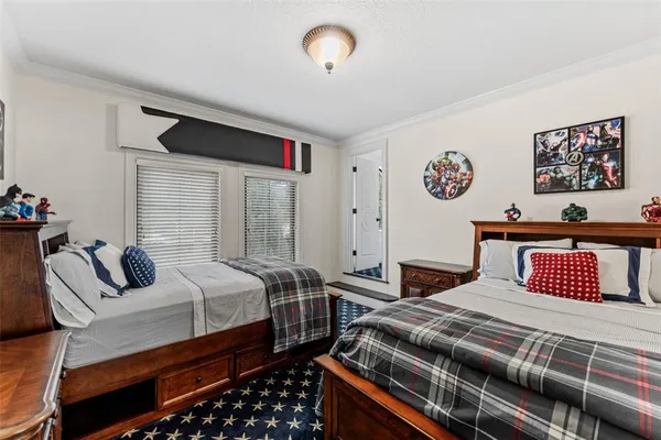 a bedroom with a bed and painting on the wall