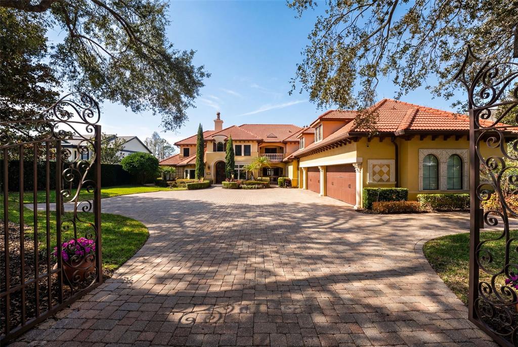 5070 Down Point Lane Windermere, FL 34786 - Photo 50 of 57 a front view of a house with a yard and potted plants
