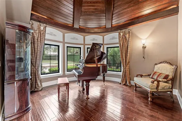 a living room with furniture a clock and a large window