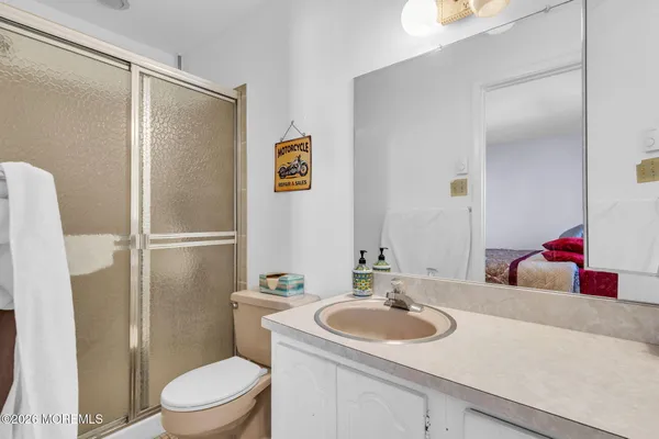 a bathroom with a sink toilet and shower