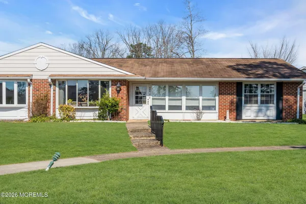a front view of a house with a yard and porch