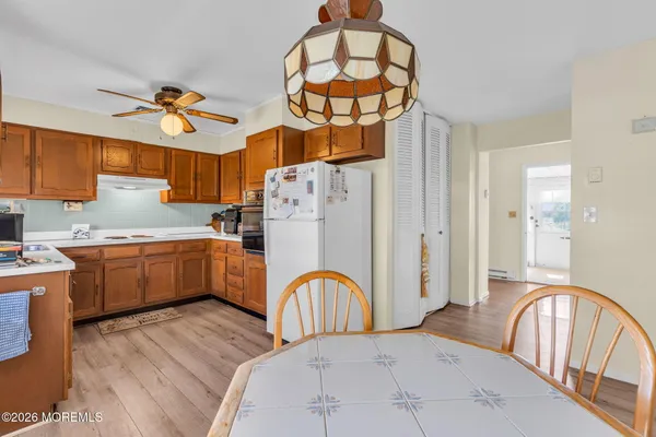 a kitchen with stainless steel appliances kitchen island a refrigerator a stove a sink dishwasher with a dining table and chairs