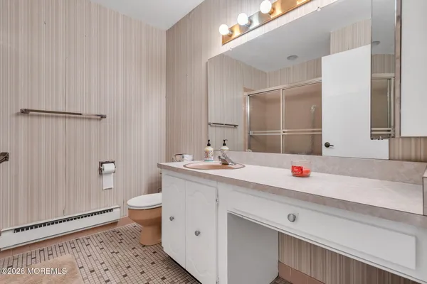 a bathroom with a sink toilet and shower