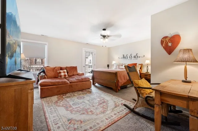 a living room with furniture a lamp and a rug