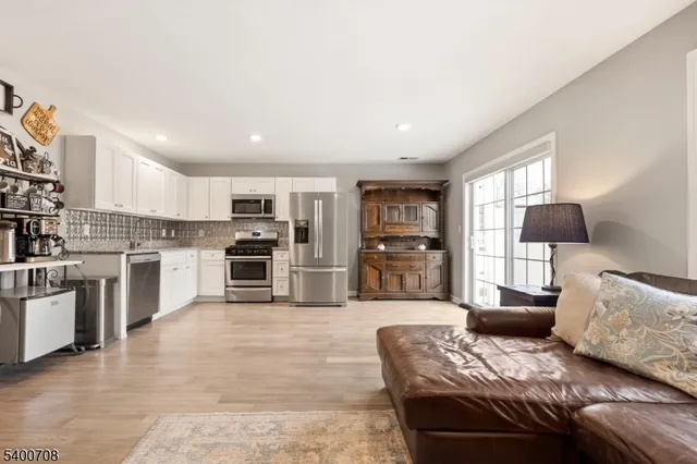 a large living room with furniture and a kitchen