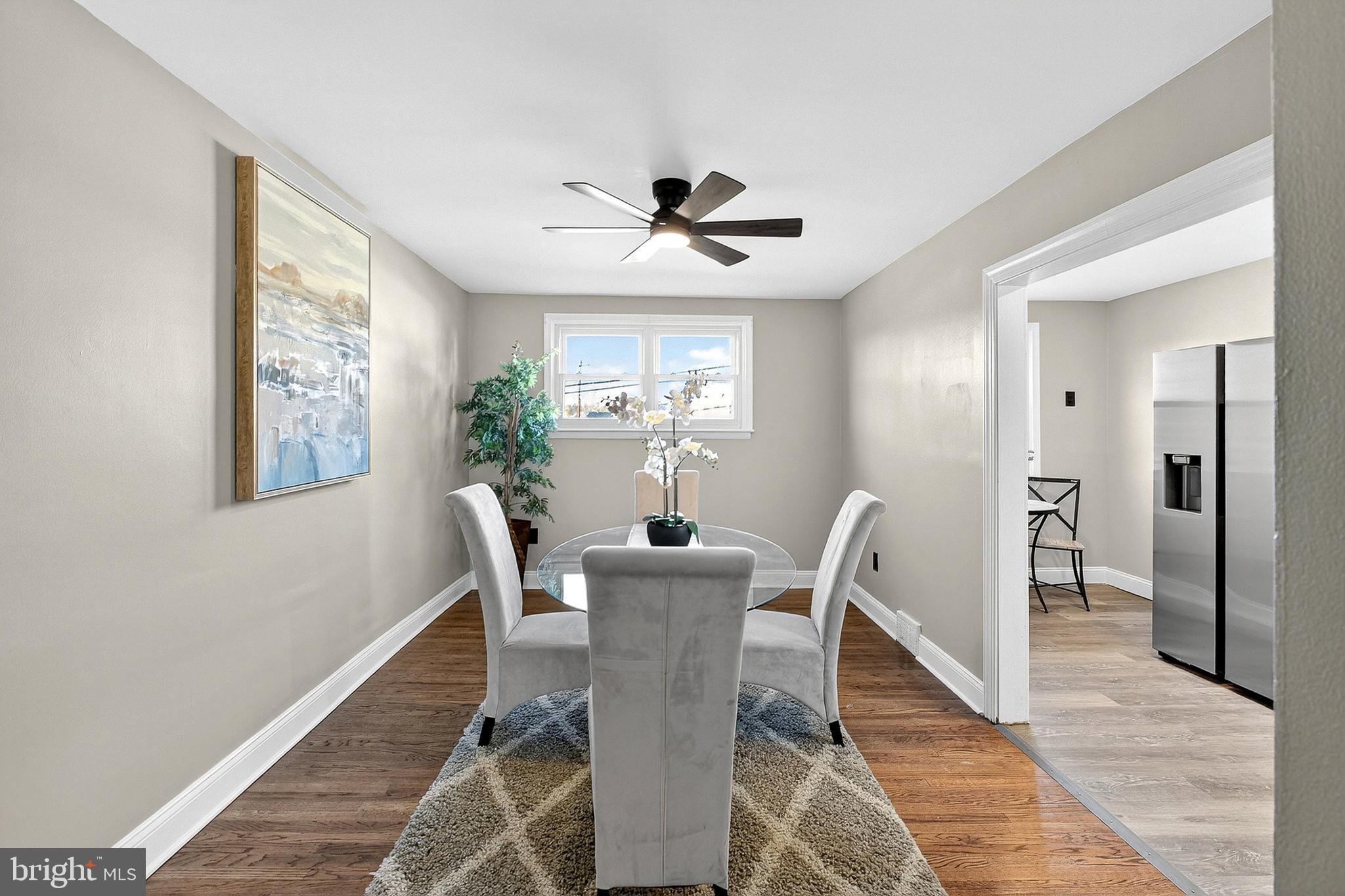 3901 Elson Road Brookhaven, PA 19015 - Photo 13 of 47 a dining room with furniture a chandelier and wooden floor