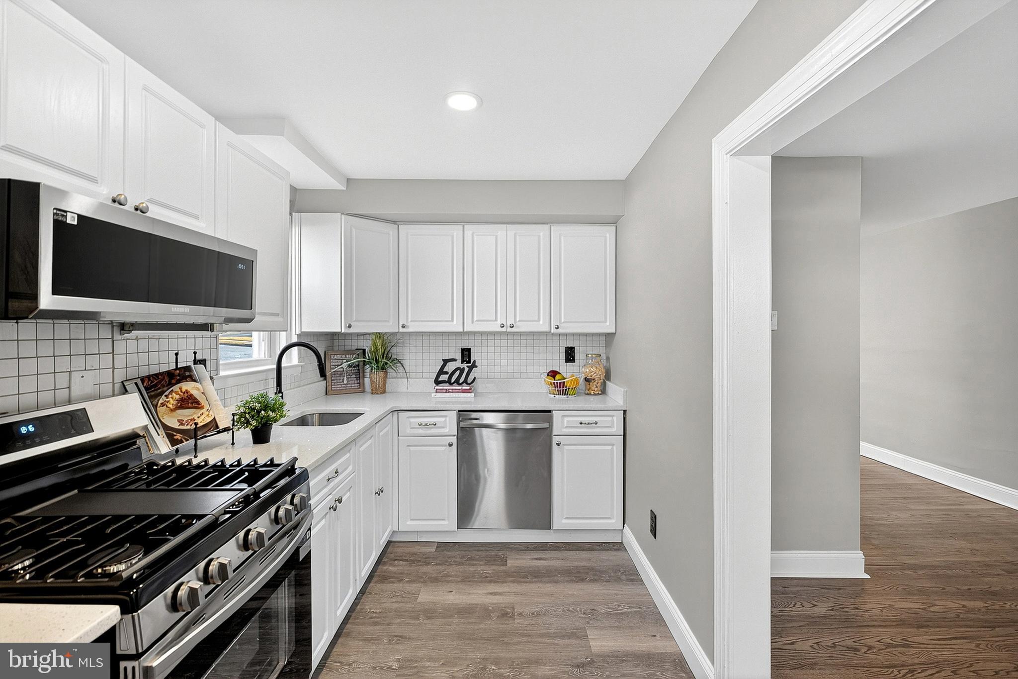 3901 Elson Road Brookhaven, PA 19015 - Photo 17 of 47 a kitchen with a stove a sink and a microwave