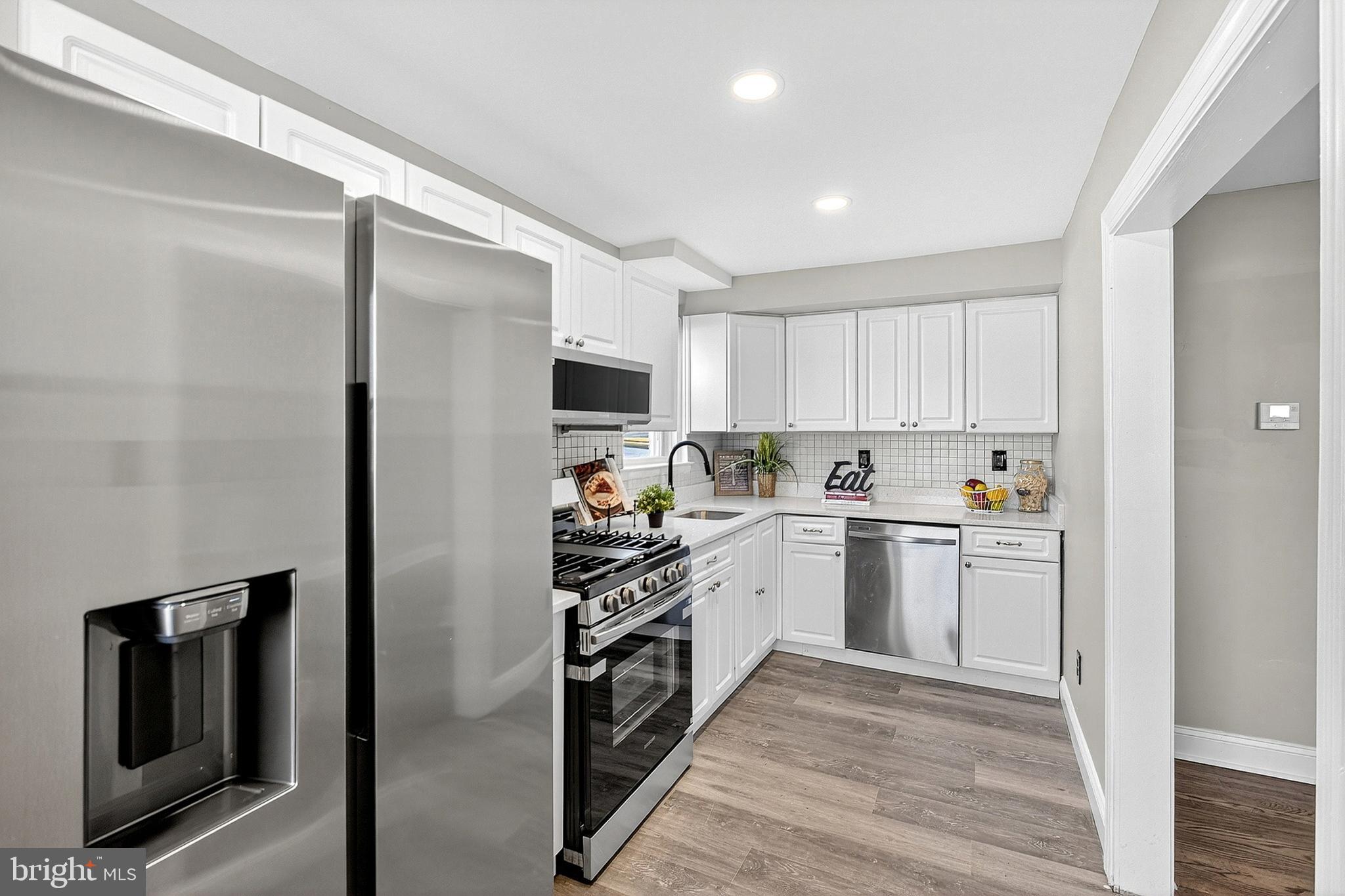 3901 Elson Road Brookhaven, PA 19015 - Photo 19 of 47 a kitchen with a refrigerator sink and cabinets