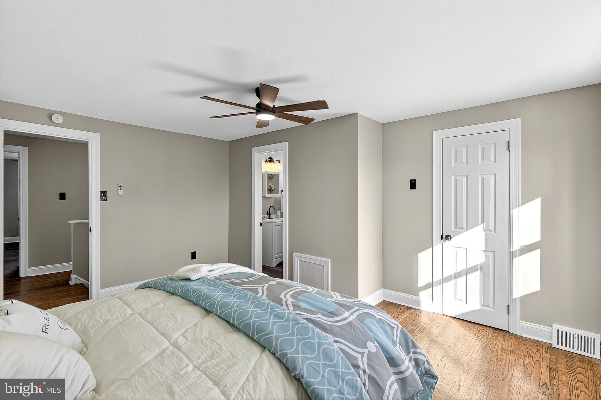 3901 Elson Road Brookhaven, PA 19015 - Photo 23 of 47 a bedroom with a large bed and a chandelier